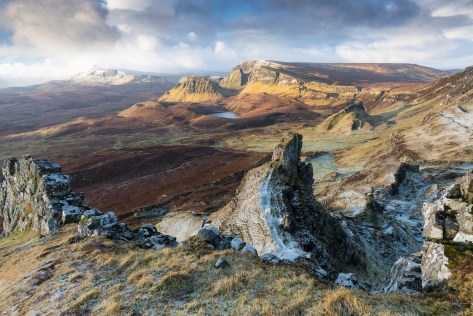 The Quiraing on the Isle of Skye, Scotland (Photo: Paul Mitchell) The Quiraing, on the northern end of the Isle of Skye, consists of Jurassic sediments overlain by thick lava flows. The rocks dip gently westwards, creating gently rising slopes from west to east. Landslides were formed due to the pressure of the overlying lava flows weighing down on the weaker Jurassic rocks. The Jurassic rocks sheared along N-S faults and huge lava blocks slide seawards along a rotational glide plane.